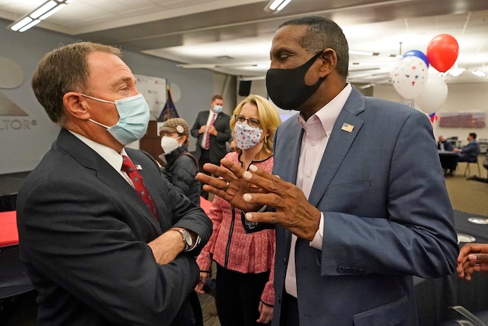 Utah Gov. Gary Herbert, left, speaks with Burgess Owens, the Republican candidate in Utah's 4th Congressional District, during a Utah Republican election night party Tuesday, Nov. 3, 2020, in Sandy, Utah. (AP Photo/Rick Bowmer)