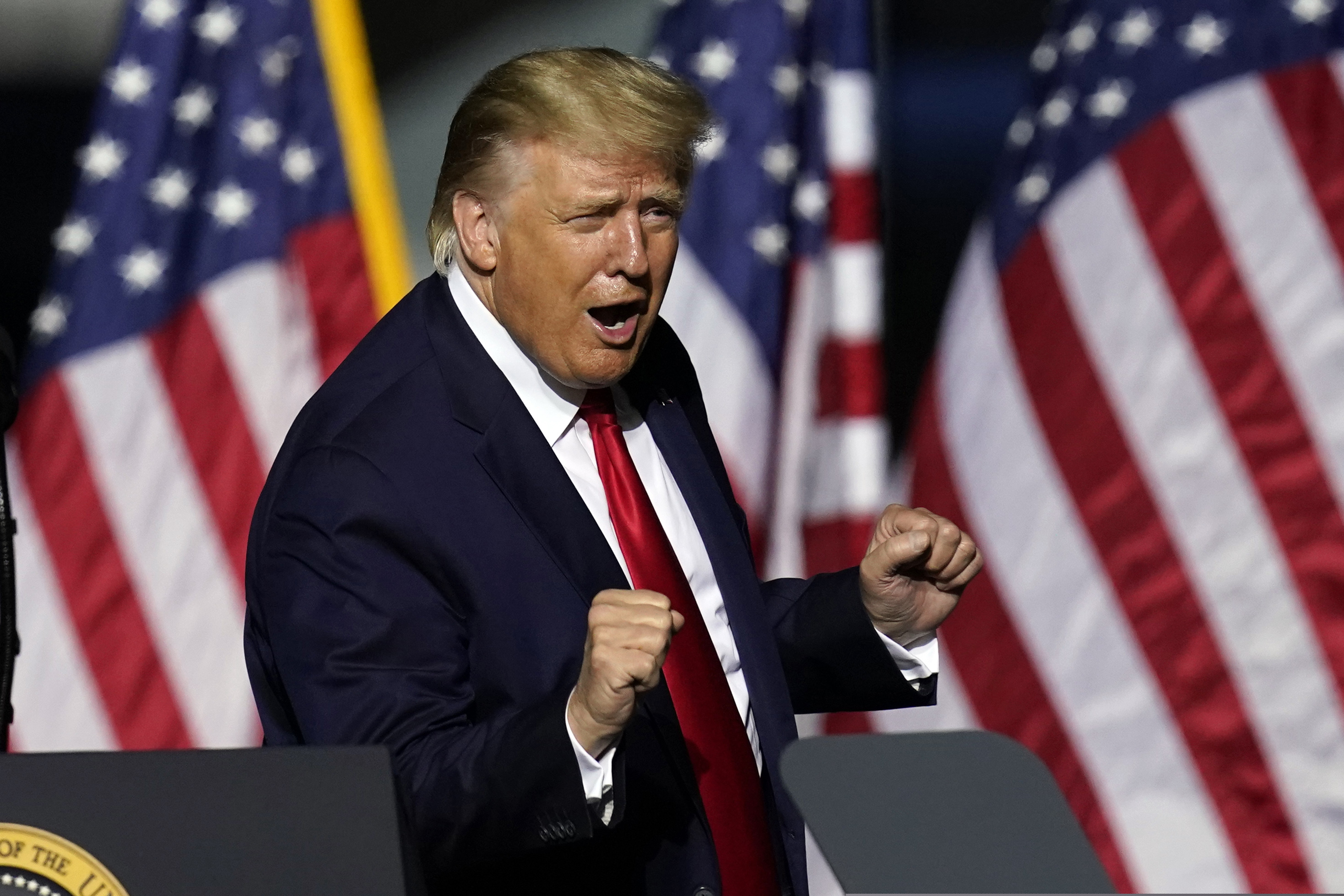In this Sept. 25, 2020 photo, President Donald Trump does a little dance after speaking at a campaign rally in Newport News, Va. Trump, a man who is famously particular about his appearance, is fully embracing doing a dad dance to the Village People's “YMCA” as the finale to his rallies in the campaign's closing stretch.  (AP Photo/Steve Helber)