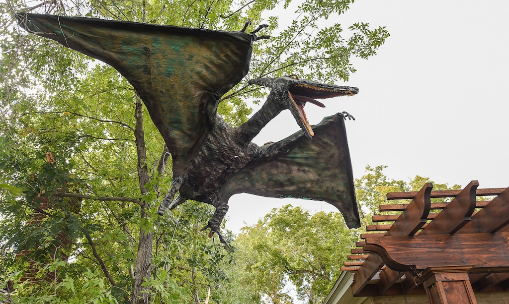 (Francisco Kjolseth | The Salt Lake Tribune) Ammon Smith went big on his front lawn at 1542 S. 900 E. in Salt Lake City for Halloween after constructing a "maturing adult" sized T-Rex along with a pair of velociraptors and pterodactyl's. The part time stay at home dad who made a giant King Kong last year, started construction back in August as he assembled recycled wood, chicken wire, foam, aluminum foil and spray paint for the 12 by 32 foot Jurassic centerpiece and companion pieces.