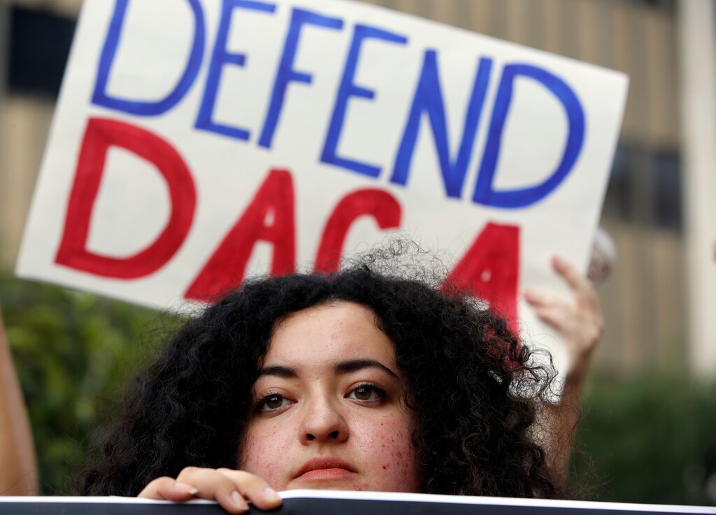 FILE - In this Sept. 1, 2017 file photo, Loyola Marymount University student and dreamer Maria Carolina Gomez joins a rally in support of the Deferred Action for Childhood Arrivals, or DACA program, outside the Edward Roybal Federal Building in Los Angeles. California's attorney general is concerned about open-ended immigration sweeps when he and other officials say the Trump administration should be concentrating on deporting dangerous felons. ecerra and former U.S. Homeland Security Secretary Janet Napolitano, now the University of California president, spoke at a news conference on Wednesday, Jan. 17, 2018 urging young immigrants to apply to remain in the country after a federal judge prevented Trump from ending the Deferred Action for Childhood Arrivals program. (AP Photo/Damian Dovarganes, File)