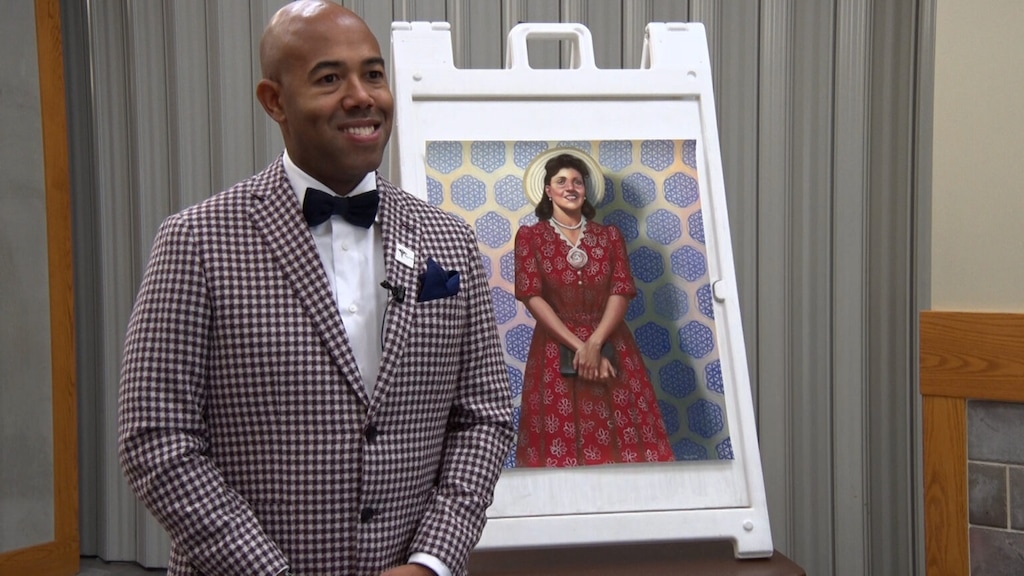 (Teresa Chaikowsky | SLCC's The Globe) Dr. Richard Ferguson, founder of Black Physicians of Utah and chief medical officer at Health Choice Utah, stands in front of a portrait of Henrietta Lacks – an African American woman whose cancer cells were the source of the “HeLa” cell line – on Dec. 5, 2023, for an event at Salt Lake Community College's Taylorsville Redwood campus, called “Someone You Knew, the Story of Henrietta Lacks.”