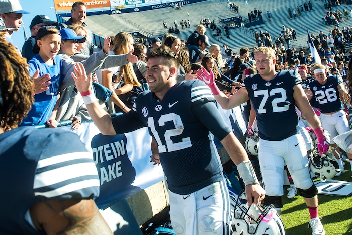 (Chris Detrick  |  The Salt Lake Tribune)  Brigham Young Cougars quarterback Tanner Mangum (12) high fives fans  after the game at LaVell Edwards Stadium Saturday, October 28, 2017.  Brigham Young Cougars defeated San Jose State Spartan 41-20.