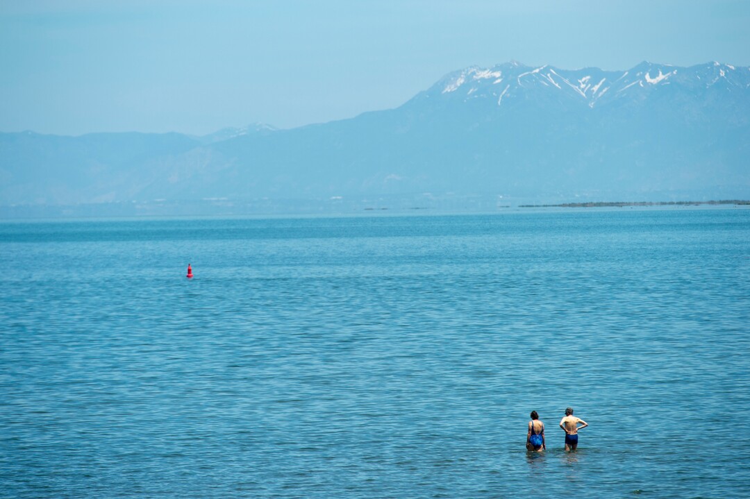 (Rick Egan  |  The Salt Lake Tribune)     Tourists wade into the water at the Great Salt Lake Marina.  The water is slowly rising again. Tuesday, June 11, 2019.