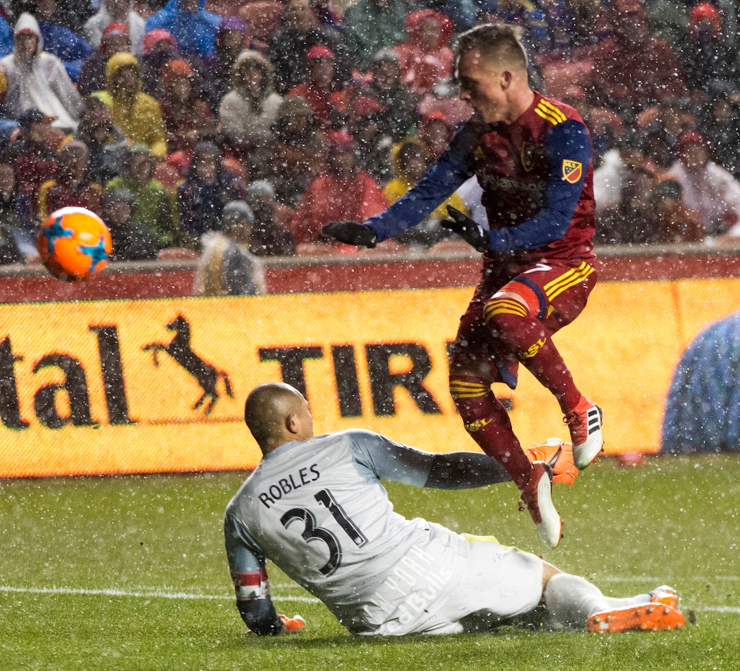 (Rick Egan  |  The Salt Lake Tribune)      Real Salt Lake forward Corey Baird (27) flies over the top of New York Red Bulls goalkeeper Luis Robles (31), in MLS action between Real Salt Lake and New York Red Bulls at Rio Tinto Stadium, Saturday, March 17, 2018.
