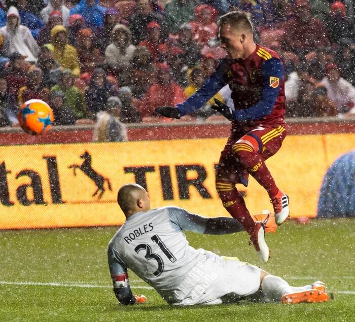 (Rick Egan  |  The Salt Lake Tribune)      Real Salt Lake forward Corey Baird (27) flies over the top of New York Red Bulls goalkeeper Luis Robles (31), in MLS action between Real Salt Lake and New York Red Bulls at Rio Tinto Stadium, Saturday, March 17, 2018.