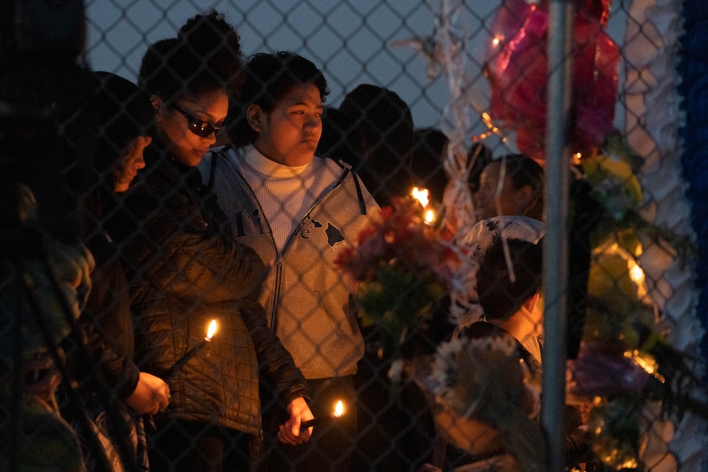 (Francisco Kjolseth | The Salt Lake Tribune) More than a hundred people gather at a candlelight vigil for Hunter High School football players Paul Tahi , 15, Tivani Lopati, 14, and Ephraim Asiata, 15, on Friday, Jan 14, 2022, in West Valley City, near Hunter High School. Paul Tahi and Tivani Lopati were killed in a shooting, while Ephraim Asiata was wounded and hospitalized.