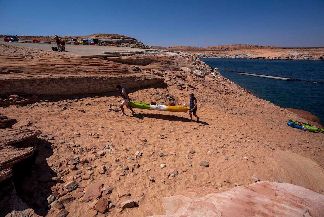 (Rick Egan | The Salt Lake Tribune)  Due to the low water levels, Kayaker's are forced to haul their kayak up the hill to the Antelope Public Launch Ramp, that now sits far above the water level, at Lake Powell, on Tuesday, Aug. 3, 2021.