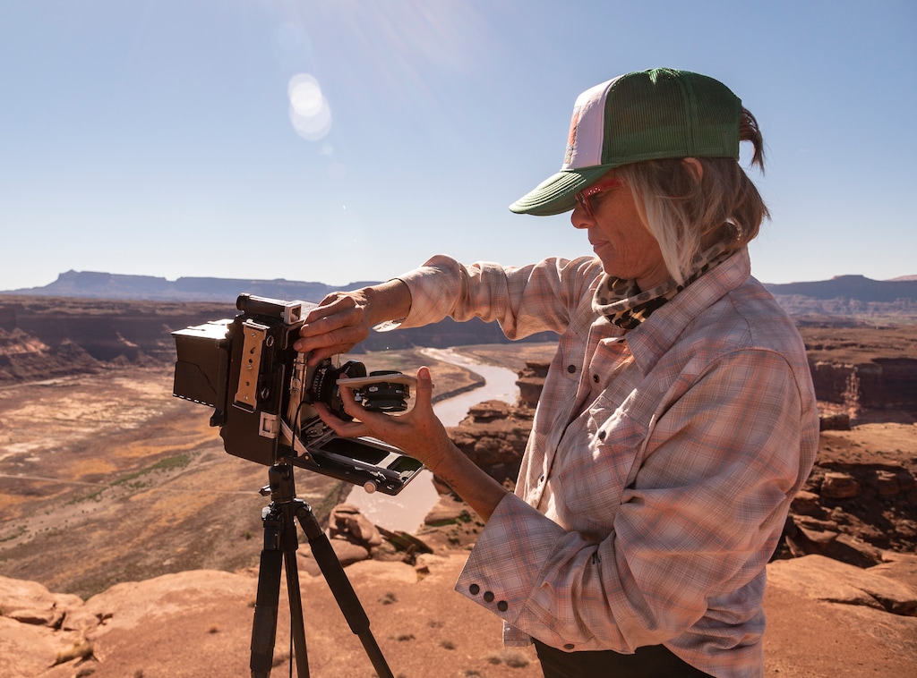 (Cierra Murrietta) Photographer Dawn Kish changes lenses on a 4x5 large format camera overlooking Hite Marina, Oct. 30 2021.