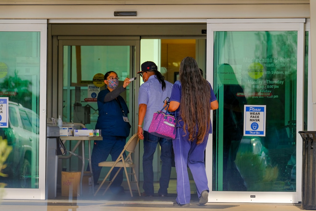(Leah Hogsten | Tribune file photo) Visitors entering Montezuma Creek Community Health Center are screened for possible COVID-19 symptoms with a temperature check, June 24, 2020.