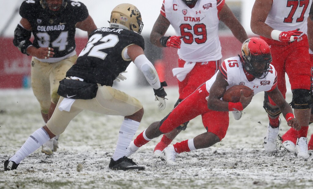 Utah quarterback Jason Shelley, right, runs for a first down as Colorado linebacker Rick Gamboa defends in the first half of an NCAA college football game Saturday, Nov. 17, 2018, in Boulder, Colo. (AP Photo/David Zalubowski)
