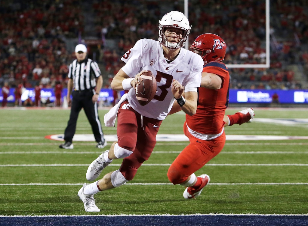 Washington State quarterback Tyler Hilinski (3) breaks the tackle of Arizona defensive lineman Luca Bruno (60) and scores a touchdown in the second half during an NCAA college football game, Saturday, Oct. 28, 2017, in Tucson, Ariz. Arizona defeated Washington State 58-37. (AP Photo/Rick Scuteri)