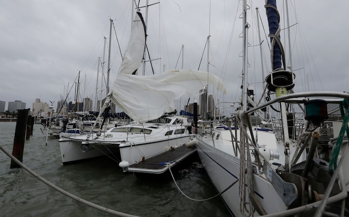 (Eric Gay | The Associated Press) Ripped sails of boats whip in the wind, damaged by Hurricane Harvey, Saturday, Aug. 26, 2017, in Corpus Christi, Texas. Harvey has been further downgraded to a Category 1 hurricane as it churns slowly inland from the Texas Gulf Coast, already depositing more than 9 inches of rain in South Texas.
