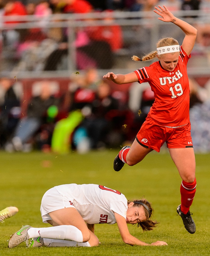 (Trent Nelson | The Salt Lake Tribune) Utah's Hailey Skolmoski (19) leaps over Stanford's Tierna Davidson (10) as the University of Utah hosts Stanford, NCAA Women's Soccer in Salt Lake City Thursday October 5, 2017.
