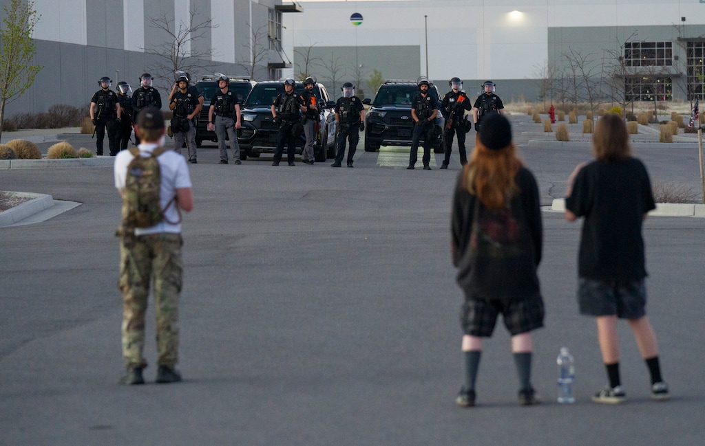 (Bethany Baker  |  The Salt Lake Tribune) Salt Lake City police officers stand guard as a protest winds down at the warehouse recently purchased by ICE, Wednesday, March 18, 2026.