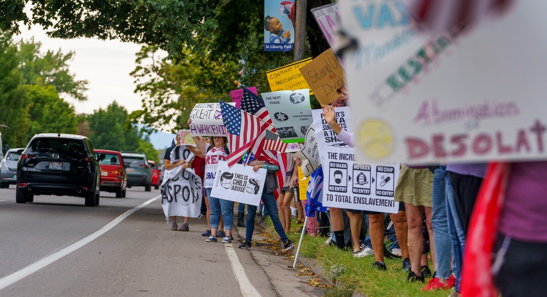 (Leah Hogsten | The Salt Lake Tribune) Protesters waving American flags and holding signs decrying mask and vaccine mandates gathered along the curb of 700 East in Liberty Park Saturday, making Salt Lake City one of dozens of cities around the world protesting public health-related restrictions, Sept. 18, 2021.