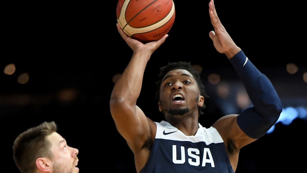 (Andy Brownbill | AP) United States' Donovan Mitchell, right, attempts a basket against Australia's Matthew Dellavedova during their exhibition basketball game in Melbourne, Saturday, Aug. 24, 2019.