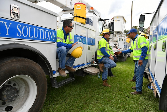 (Mike Lang | Sarasota Herald-Tribune | The Associated Press) Pike Electric power restoration workers wait instructions after arriving at the Saraosta Fairgrounds on Tuesday, Oct. 9, 2018. Florida Power & Light is staging contractors in Sarasota, Fla, in advance of Hurricane Michael's expected landfall in the Florida panhandle later this week.