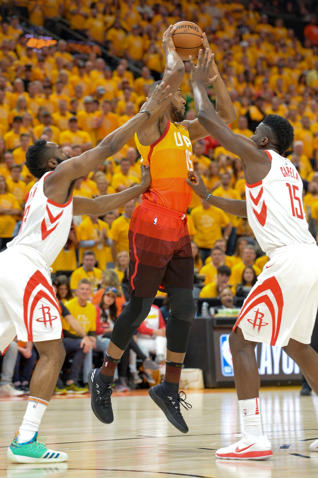 (Leah Hogsten  |  The Salt Lake Tribune) Utah Jazz forward Derrick Favors (15) is pressured by Houston Rockets guard James Harden (13) and Houston Rockets center Clint Capela (15) as the Utah Jazz take on the Houston Rockets in Game 3 of an NBA basketball second-round playoff series Friday, May 4, 2018 in Salt Lake City.