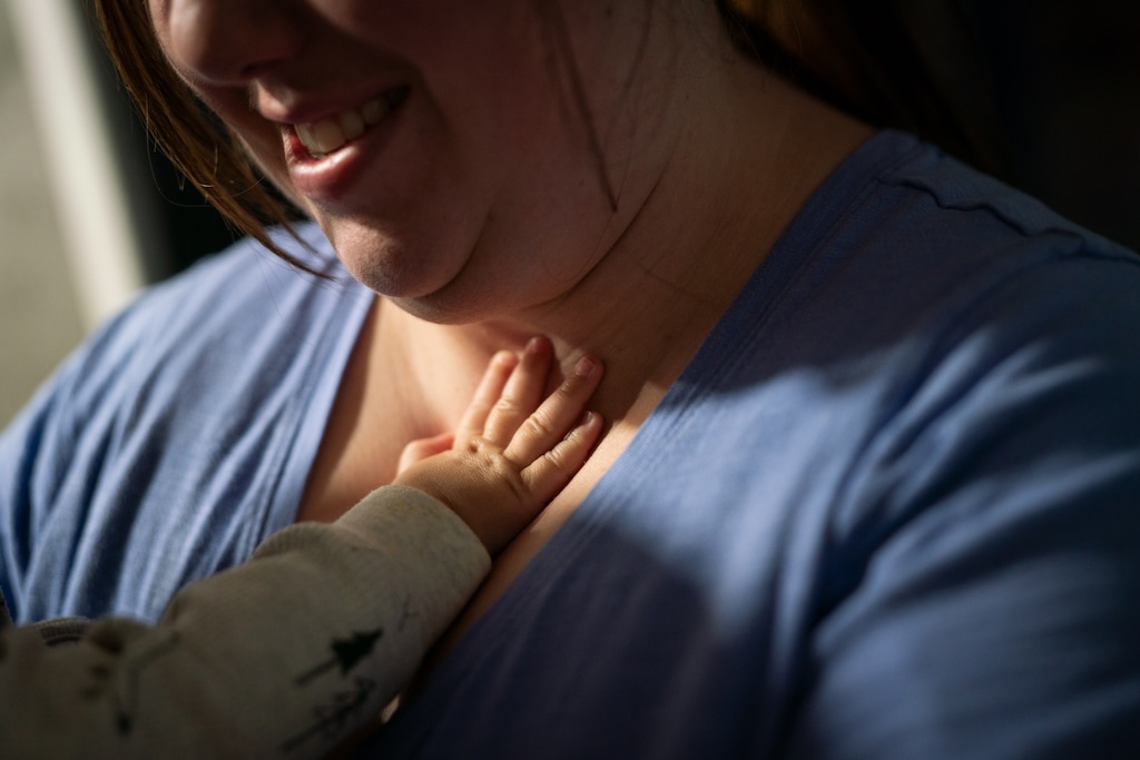 (Sarahbeth Maney | ProPublica) Aleatha Child holds a 7-month-old child at her home day care in Brigham City.