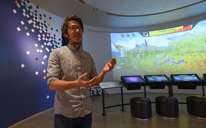 (Francisco Kjolseth  |  The Salt Lake Tribune)  Tim Lee, Senior Exhibit Designer for the Natural History Museum of Utah at the Rio Tinto Center describes a new multiplayer game called Utah Climate Challenge, to help visitors consider issues of sustainability, biodiversity, population growth and urban sprawl. Located in the Utah Futures Gallery, the game is designed by Preloaded, a London-based company that specializes in designing games with a purpose to tackle complicated issues for a general audience.