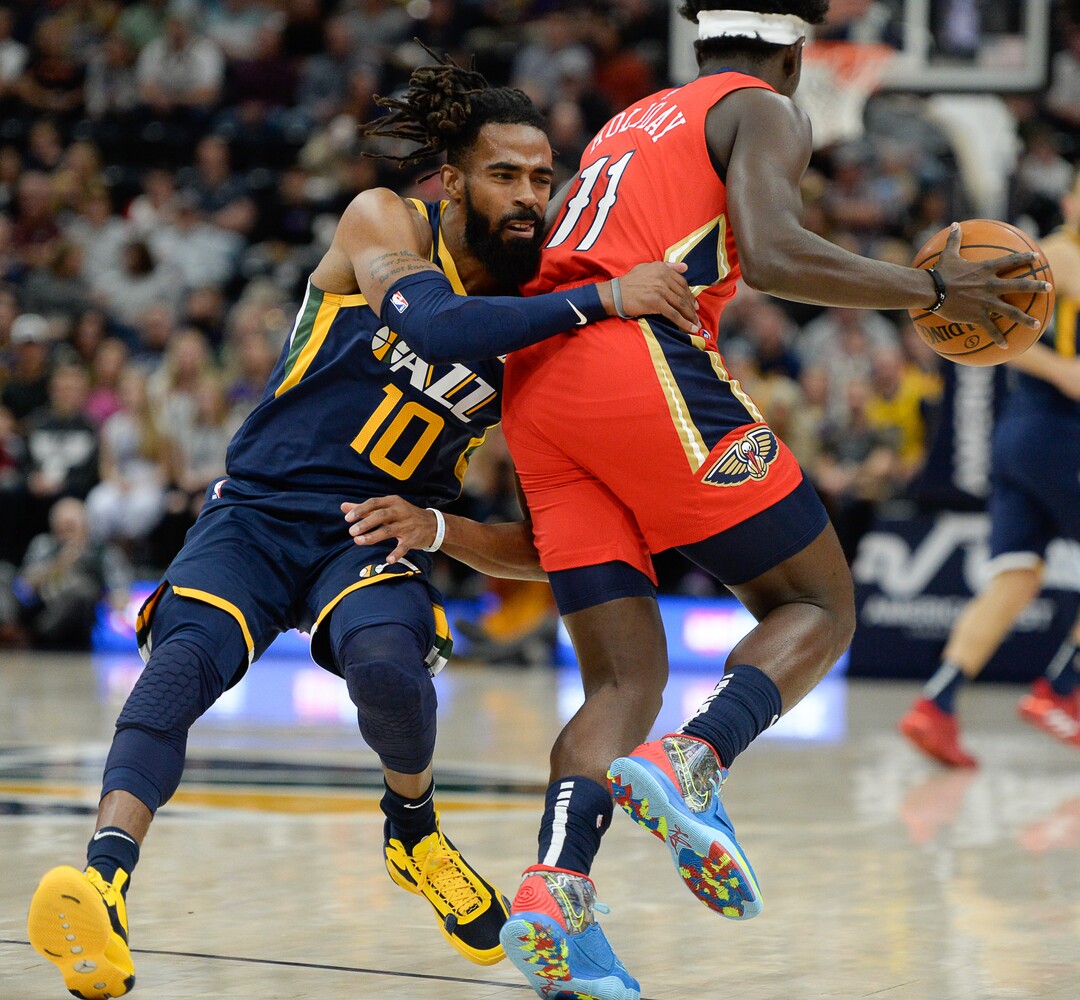 (Francisco Kjolseth  |  The Salt Lake Tribune)  Utah Jazz guard Mike Conley (10) gets pushed over by New Orleans Pelicans guard Jrue Holiday (11) as the Utah Jazz host the New Orleans Pelicans in their NBA basketball game at Vivint Smart Home Arena in Salt Lake City on Sat. Nov. 23, 2019.