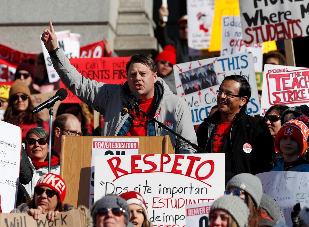 Rob Gould, center left, a special education teacher and lead Denver Classroom Teachers Association negotiator, and Henry Roman, center right, president of the teachers union, speak to teachers during a strike rally on the west steps of the State Capitol Monday, Feb. 11, 2019, in Denver. The strike is the first for teachers in Denver since 1994 and centers on base pay. (AP Photo/David Zalubowski)