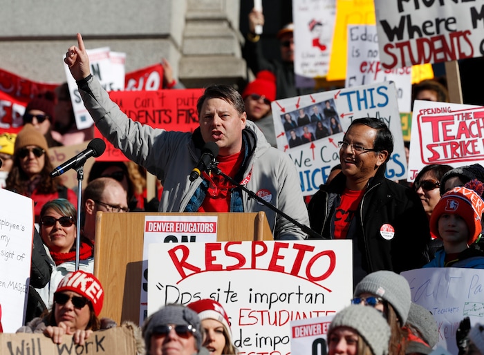 Rob Gould, center left, a special education teacher and lead Denver Classroom Teachers Association negotiator, and Henry Roman, center right, president of the teachers union, speak to teachers during a strike rally on the west steps of the State Capitol Monday, Feb. 11, 2019, in Denver. The strike is the first for teachers in Denver since 1994 and centers on base pay. (AP Photo/David Zalubowski)