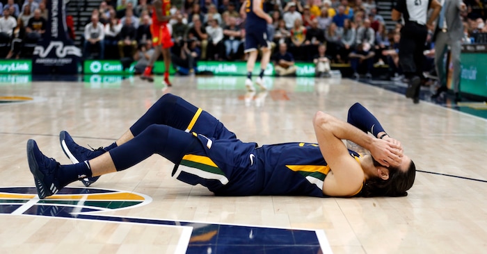 Utah Jazz guard Ricky Rubio falls to the court after a foul from Atlanta Hawks guard Dennis Schroeder during the second half of an NBA basketball game Tuesday, March 20, 2018, in Salt Lake City. (AP Photo/Rick Bowmer)