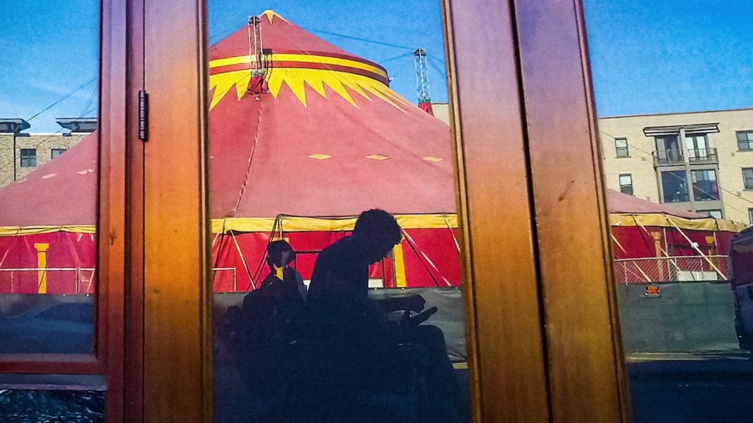 (Reid Davenport  |  Sundance Institute) Filmmaker Reid Davenport captures a reflection of himself and a massive circus tent near his home in Oakland, Calif., which is the basis for the documentary "I Didn't See You There," directed by Davenport, an official selection of the U.S. Documentary competition at the 2022 Sundance Film Festival.