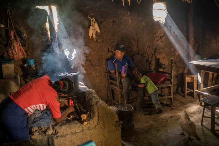 (Daniele Volpe | The New York Times) Eduardo Roque, an indigenous farmer, and family in the mud home he built by hand in La Palmilla, in the Chiquimula region of Guatemala, July 23, 2020. Around the world, the poor and marginalized are much more likely to be vulnerable to extreme heat; in the past decade, five long and harsh late summer droughts have cursed this region known as the "Dry Corridor."