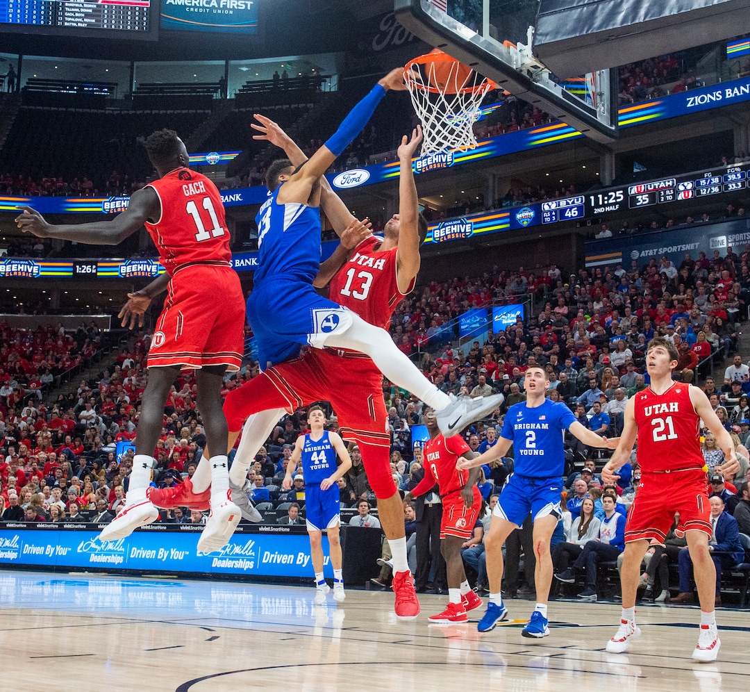(Rick Egan  |  The Salt Lake Tribune)   Brigham Young Cougars forward Yoeli Childs (23) goes in for a slam-dunk as Utah Utes forward Both Gach (11) and  forward Novak Topalovic (13) defend, in basketball action in the Beehive Classic, between against the Brigham Young Cougars and Utah Utes, a the Vivint Smart Home Arena, Saturday December 8, 2018.