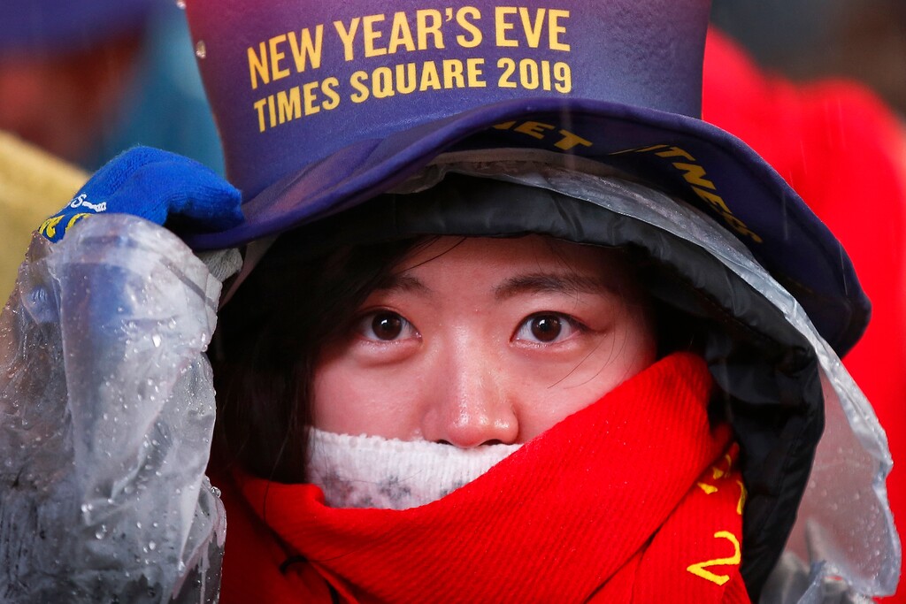 A reveler adjusts her hat as she waits in Times Square in New York on Monday, Dec. 31, 2018, while taking part in a New Year's Eve celebration. (AP Photo/Adam Hunger)