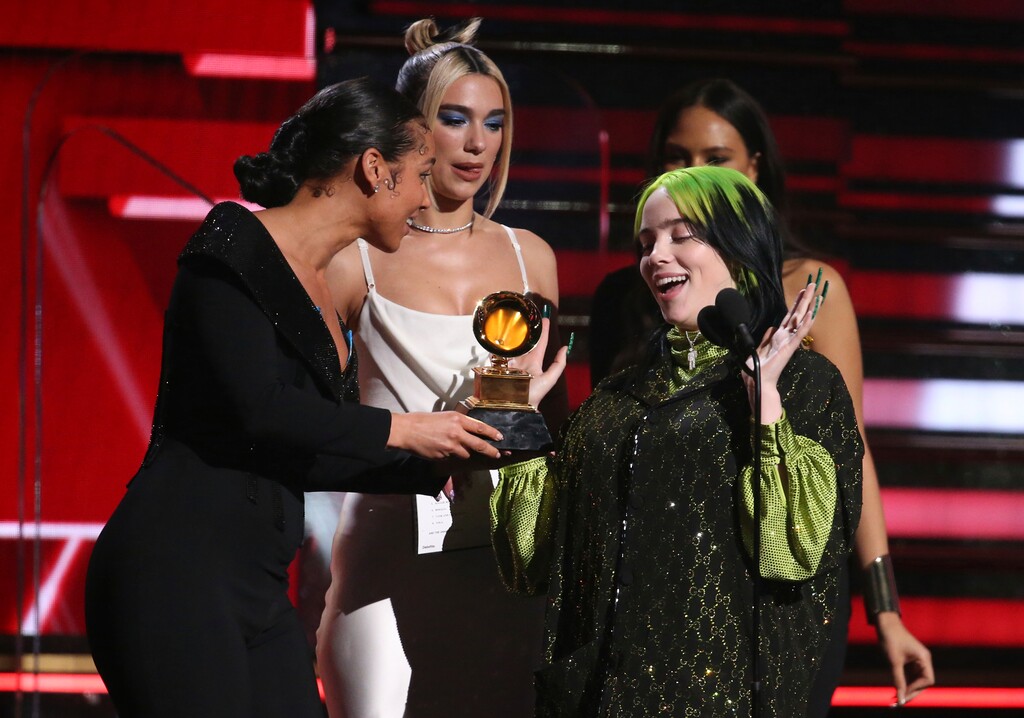 (Matt Sayles | Invision/AP)  Alicia Keys, from left, and Dua Lipa present Billie Eilish with the award for best new artist at the 62nd annual Grammy Awards on Sunday, Jan. 26, 2020, in Los Angeles.