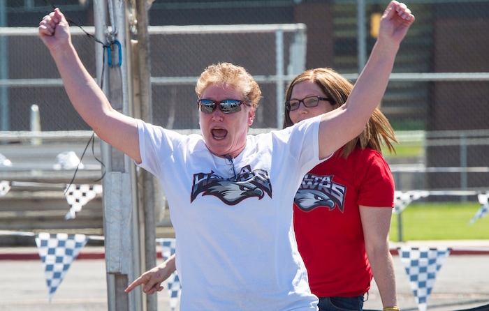 (Rick Egan  |  The Salt Lake Tribune)      Alta High teachers Heather Starley and Sarah Conner, cheer for their students as the parade of 2020 graduates drive by in a “drive through” graduation ceremony at Alta High, Thursday, May 28, 2020.