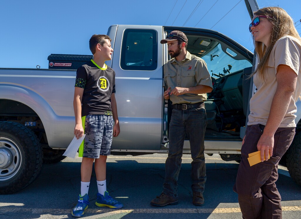 Leah Hogsten  |  The Salt Lake Tribune   l-r Tyler Peterson, 13, talks with Utah Division of Wildlife Resources predator management specialist, Jeff Cowlishaw and predator control program manager Xaela Walden documents coyote remains brought to them by  Peterson, who shot the coyote in Box Elder County last week.  Utah Division of Wildlife Resources predator-control program provides a $50 incentive for hunters to kill and properly document every coyote that they kill in Utah. Despite its success, the program is getting an overhaul to reign in criminal abuses and obtain better data to help officials assess what the program is accomplishing in terms of protecting mule deer and controlling predators.INFORMATION-> We are meeting Xaela Walden, Wednesday, June 20, 2018 