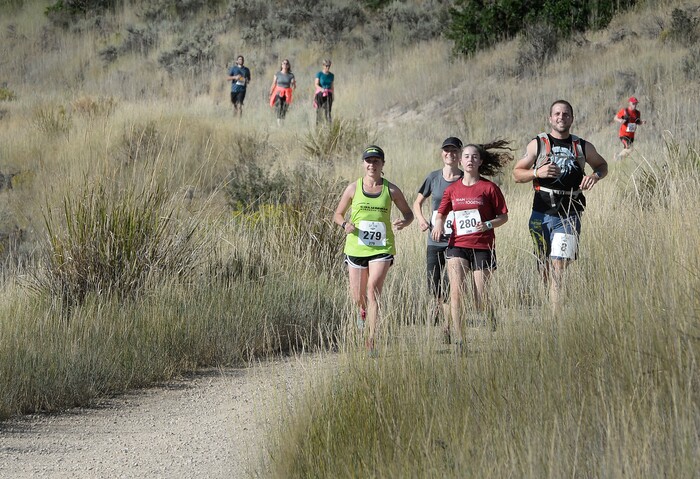(Scott Sommerdorf | The Salt Lake Tribune) Runners race toward the finish line near the Soldier Hollow train station as they compete against the Heber Creeper train in a 12k race. The race started at the Deer Creek Dam, Saturday, August 19, 2017.