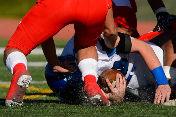 (Trent Nelson | The Salt Lake Tribune)
Pleasant Grove quarterback Jake Jensen (18) is tackled as East hosts Pleasant Grove in the first round of the 6A high school football playoffs, Friday Oct. 26, 2018.