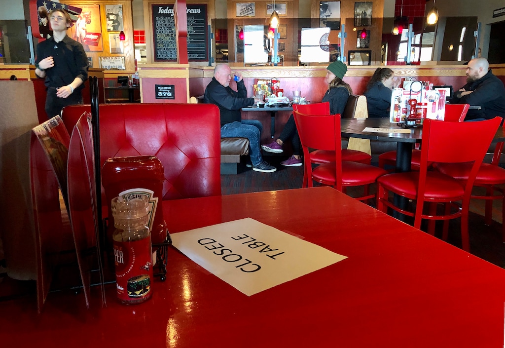 (Gillian Flaccus | AP) A Red Robin reastaurant in Tigard, Ore., has closed some tables in order to maintain 'social distancing' between diners per CDC guidelines Sunday, March 15, 2020. They said they were running the place at 50 percent capacity so they could leave tables empty between customers.