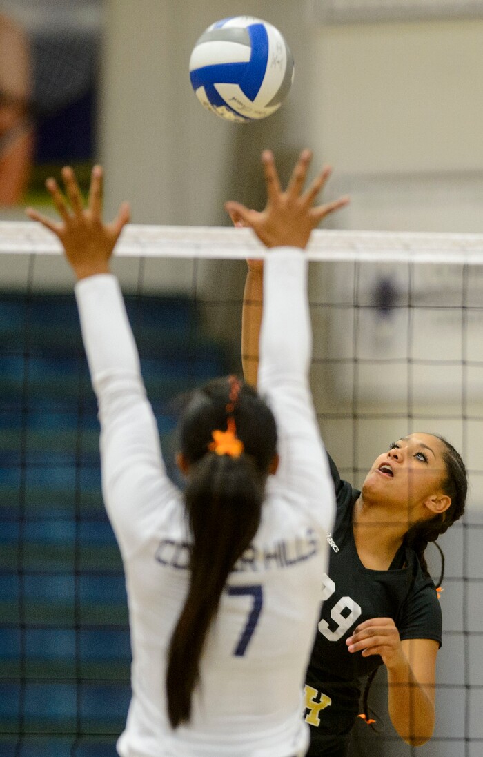 (Steve Griffin | The Salt Lake Tribune) Herriman's Jasmyne Love fires a shot over Aliyah Sopoaga of Copper Hills during volleyball match at Copper Hills High School in West Jordan Tuesday September 26, 2017.