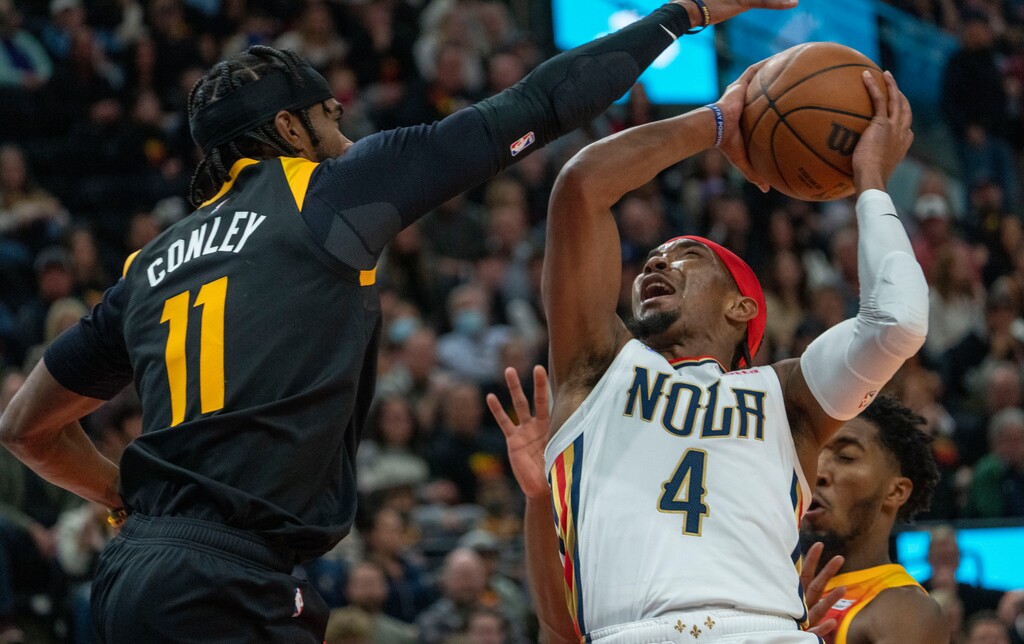 (Rick Egan | The Salt Lake Tribune) New Orleans Pelicans guard Devonte' Graham (4) goes inside for a shot, asa Utah Jazz guard Mike Conley (11) defends, in NBA action between the Utah Jazz and the New Orleans Pelicans, on Saturday, Nov. 27, 2021.