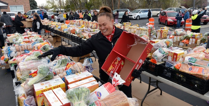 (Al Hartmann | The Salt Lake Tribune)
Volunteer Nola Tuaone of the Utah Food Bank helps pack food boxes in the parking lot of the LDS Church at 1860 S. 300 E. in Salt Lake City Friday April 13. She volunteers every Friday. It's one of 18 locations the bank operates to get food out to the food insecure. An army of volunteers make the distrbution system work. Walmart, Feeding America and Utah Food Bank are teaming up during the month of April to fight hunger through an online and in-store donation campaign.