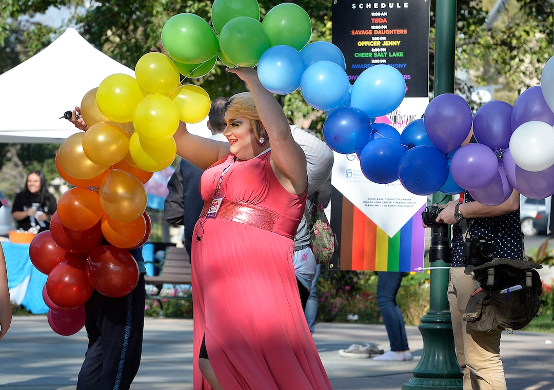 (Scott Sommerdorf   |  The Salt Lake Tribune)   "Jackie O. Star" - or James Bunker, President of Provo Pride, passes beneath some rainbow balloons at the fifth annual Provo Pride Festival, Saturday, September 16, 2017.