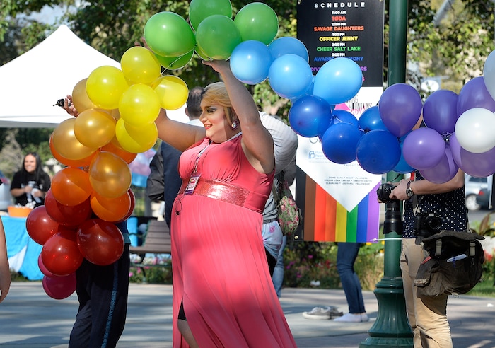 (Scott Sommerdorf   |  The Salt Lake Tribune)   
"Jackie O. Star" - or James Bunker, President of Provo Pride, passes beneath some rainbow balloons at the fifth annual Provo Pride Festival, Saturday, September 16, 2017.