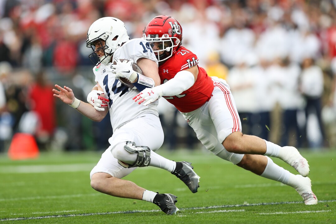 (Meg Oliphant | Special to The Tribune) Karene Reid (21) of the Utah Utes tackles Sean Clifford (14) of the Penn State Nittany Lions in the first quarter at Rose Bowl Stadium on Jan. 2, 2023 in Pasadena, Calif.