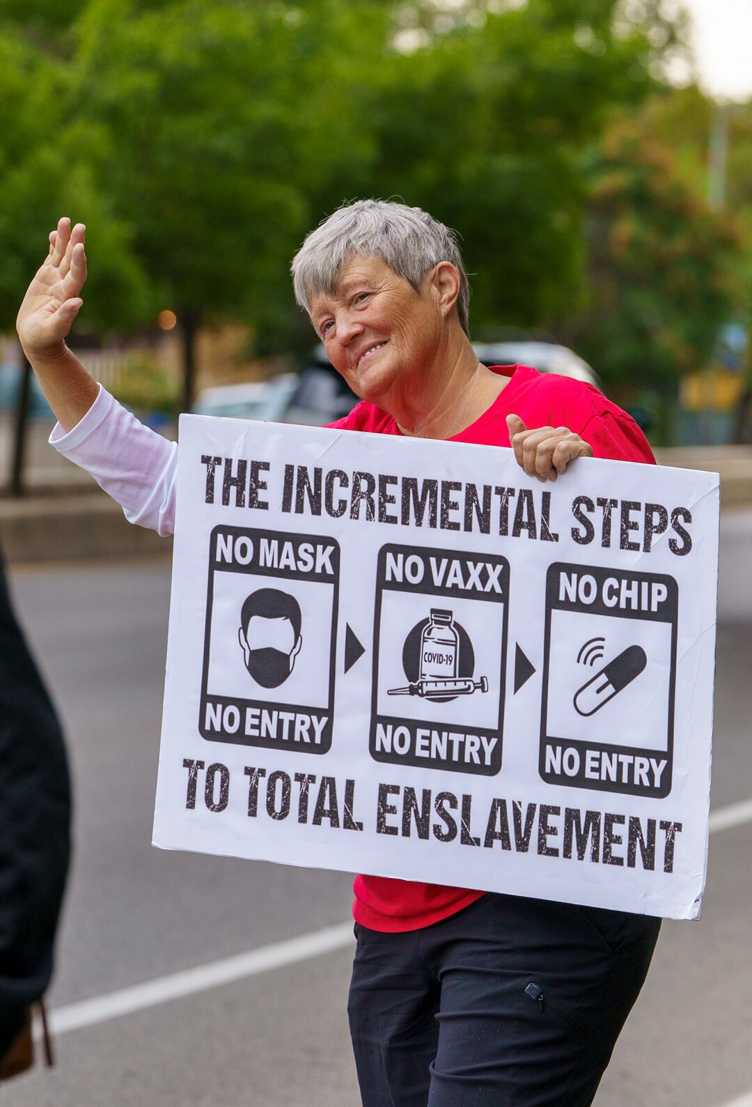 (Leah Hogsten | The Salt Lake Tribune) Protesters waving American flags and holding signs decrying mask and vaccine mandates gathered along the curb of 700 East in Liberty Park Saturday, making Salt Lake City one of dozens of cities around the world protesting public health-related restrictions, Sept. 18, 2021.