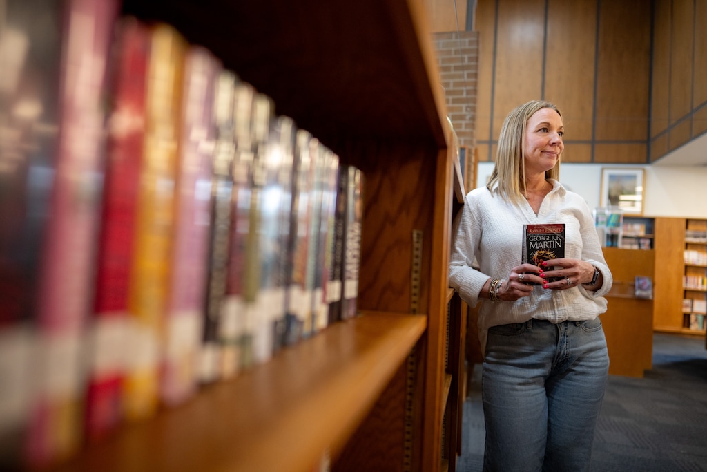 (Trent Nelson  |  The Salt Lake Tribune) Librarian Kara Budge holds a newly banned book, George R. R. Martin's "A Clash of Kings", at West High School in Salt Lake City on Wednesday, April 29, 2026.