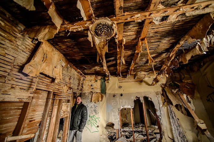 (Trent Nelson | The Salt Lake Tribune) Jordon Holdaway in a dilapidated, fire-damaged building near 100 South 700 East in Salt Lake City, Thursday Feb. 15, 2018. Other Side Academy has received approval to demolish it for their expansion.