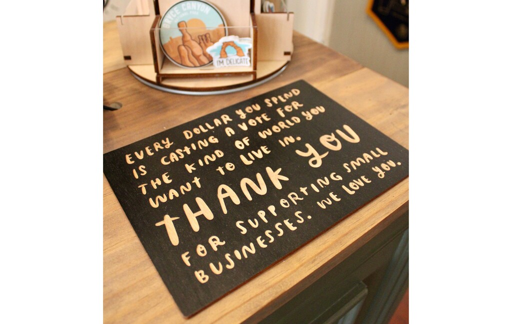 (Lexy Borgogno | The Southern Utah Tribune) A sign at Rise & Wander, a locally owned shop in St. George. The store carries Americana vibe gifts, clothing and candles, including items from purpose-driven brands.