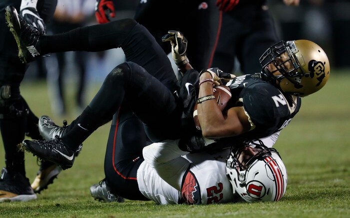 Utah defensive back Chase Hansen, bottom, tackles Colorado wide receiver Devin Ross in the second half of an NCAA college football game Saturday, Nov. 26, 2016, in Boulder, Colo. Colorado won 27-22. (AP Photo/David Zalubowski)