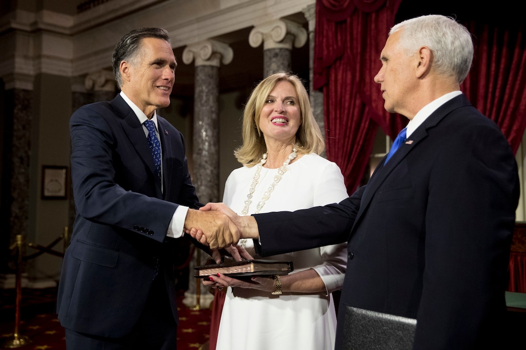 Vice President Mike Pence shakes hands with Sen. Mitt Romney, R-Utah, accompanied by his wife Ann, following a mock swearing in ceremony in the Old Senate Chamber on Capitol Hill in Washington, Thursday, Jan. 3, 2019, as the 116th Congress begins. (AP Photo/Andrew Harnik)